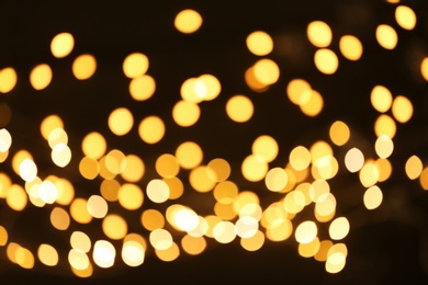 Photo of Beautiful golden lights on dark background. Bokeh effect