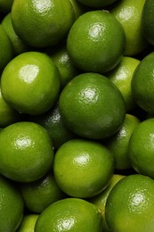 Photo of Many fresh ripe limes as background, top view