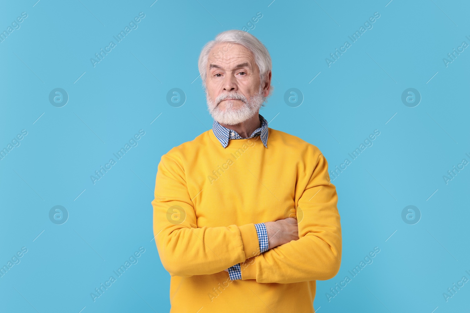 Photo of Portrait of stylish grandpa on light blue background