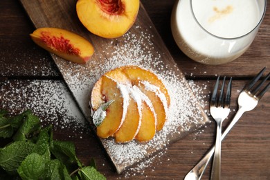 Photo of Delicious peach dessert on wooden table, flat lay