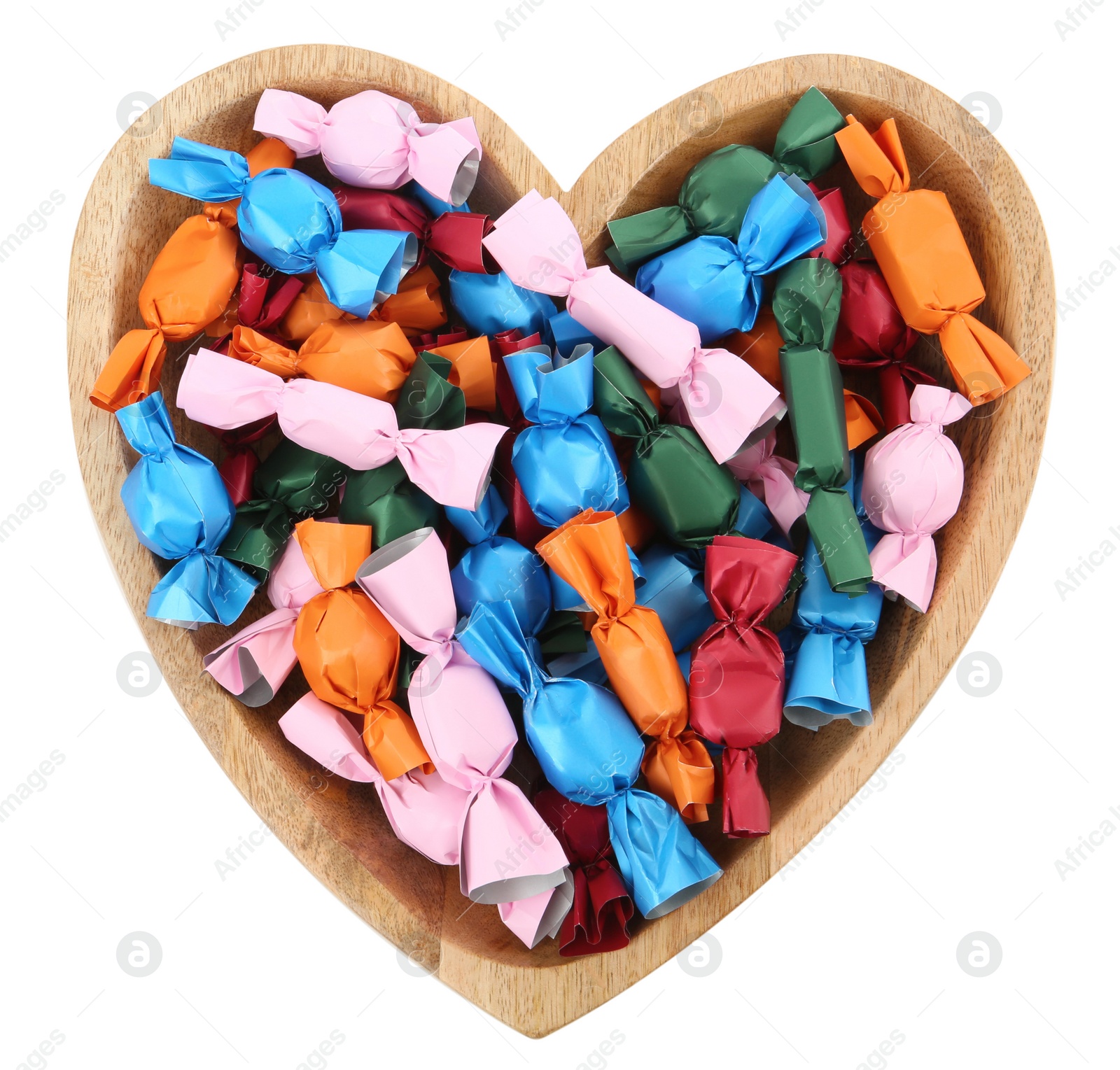 Photo of Heart shaped plate with candies in colorful wrappers isolated on white, top view