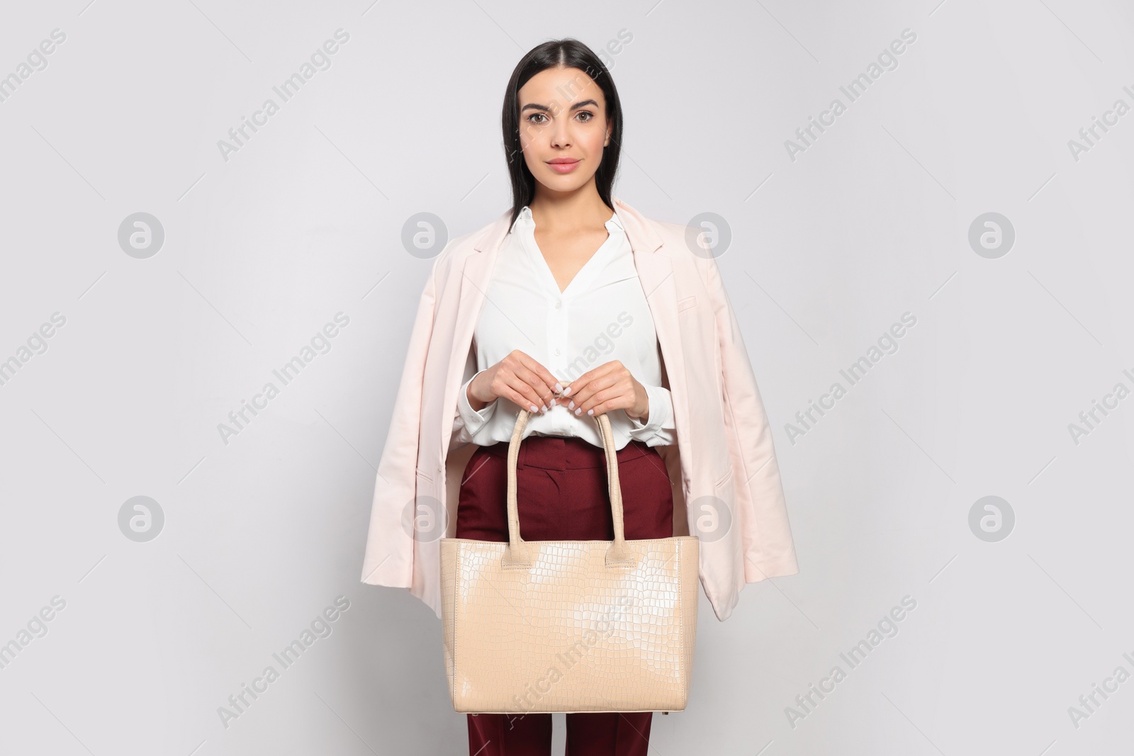 Photo of Young woman with stylish bag on white background