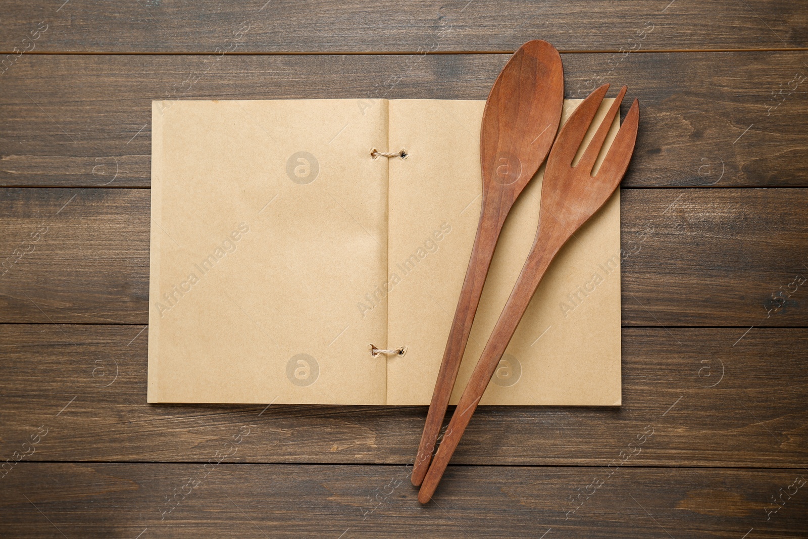 Photo of Blank recipe book and kitchen utensils on wooden table, flat lay. Space for text