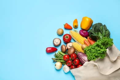 Different fresh vegetables on light blue background, flat lay. Space for text