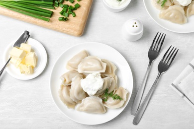 Photo of Flat lay composition with tasty dumplings served on white table