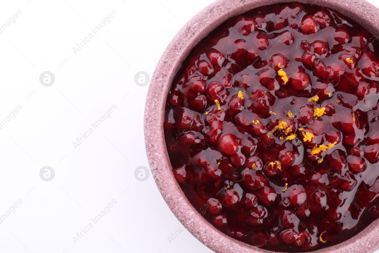 Photo of Tasty cranberry sauce in bowl isolated on white, top view