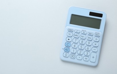 Modern calculator on white background, top view. Space for text