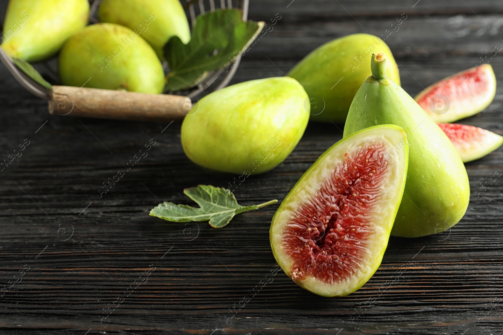 Photo of Fresh ripe figs on wooden table. Tropical fruit