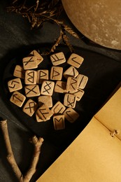 Photo of Composition with wooden runes on black marble table, flat lay