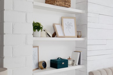 Photo of Wall shelves with beautiful decor elements indoors. Interior design