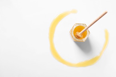 Photo of Jar with tasty natural honey and dipper on white background, top view