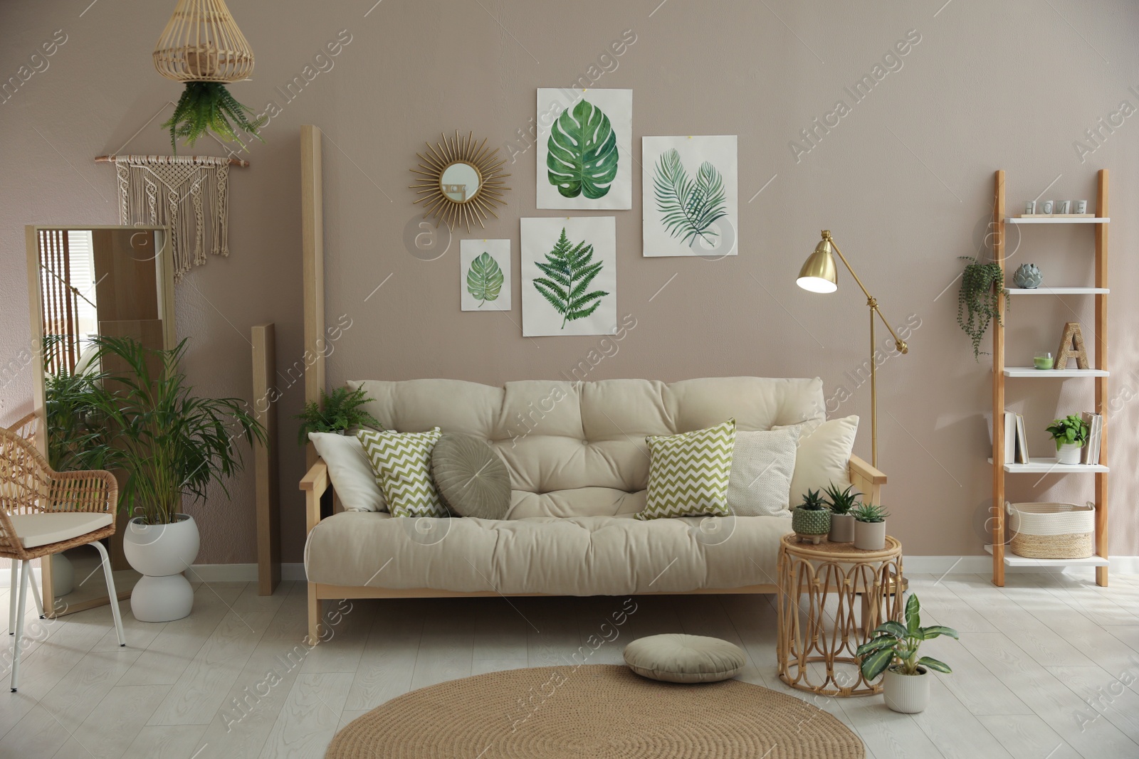 Photo of Stylish living room interior with comfortable sofa and beautiful pictures on wall