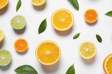 Flat lay composition with different citrus fruits on white background