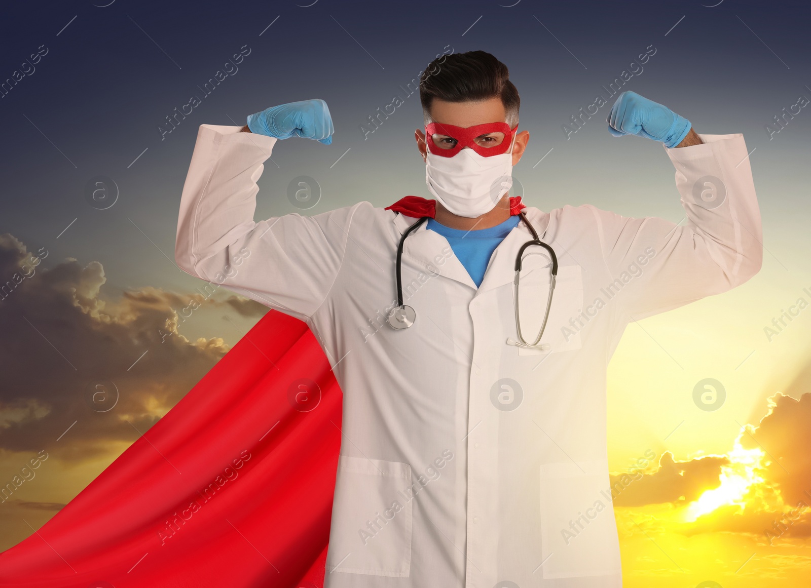 Image of Medical workers fighting with dangerous diseases. Doctor dressed as superhero posing against sky