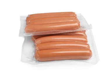 Photo of Packs of fresh raw sausages isolated on white. Ingredients for hot dogs