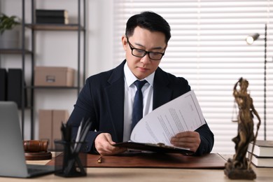 Notary working at wooden table in office