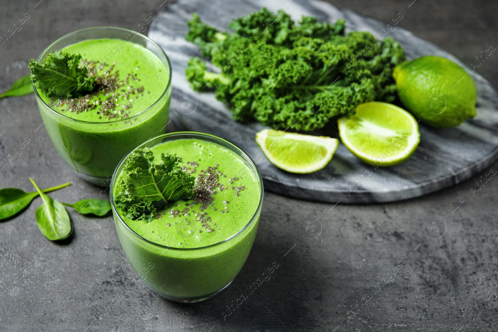 Photo of Tasty kale smoothie with chia seeds on grey table