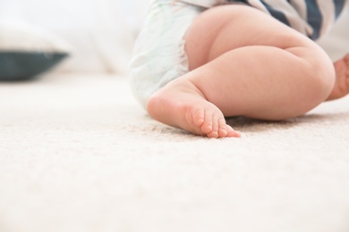 Cute little baby on carpet indoors, closeup with space for text. Crawling time