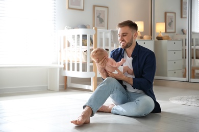 Father with his newborn son at home