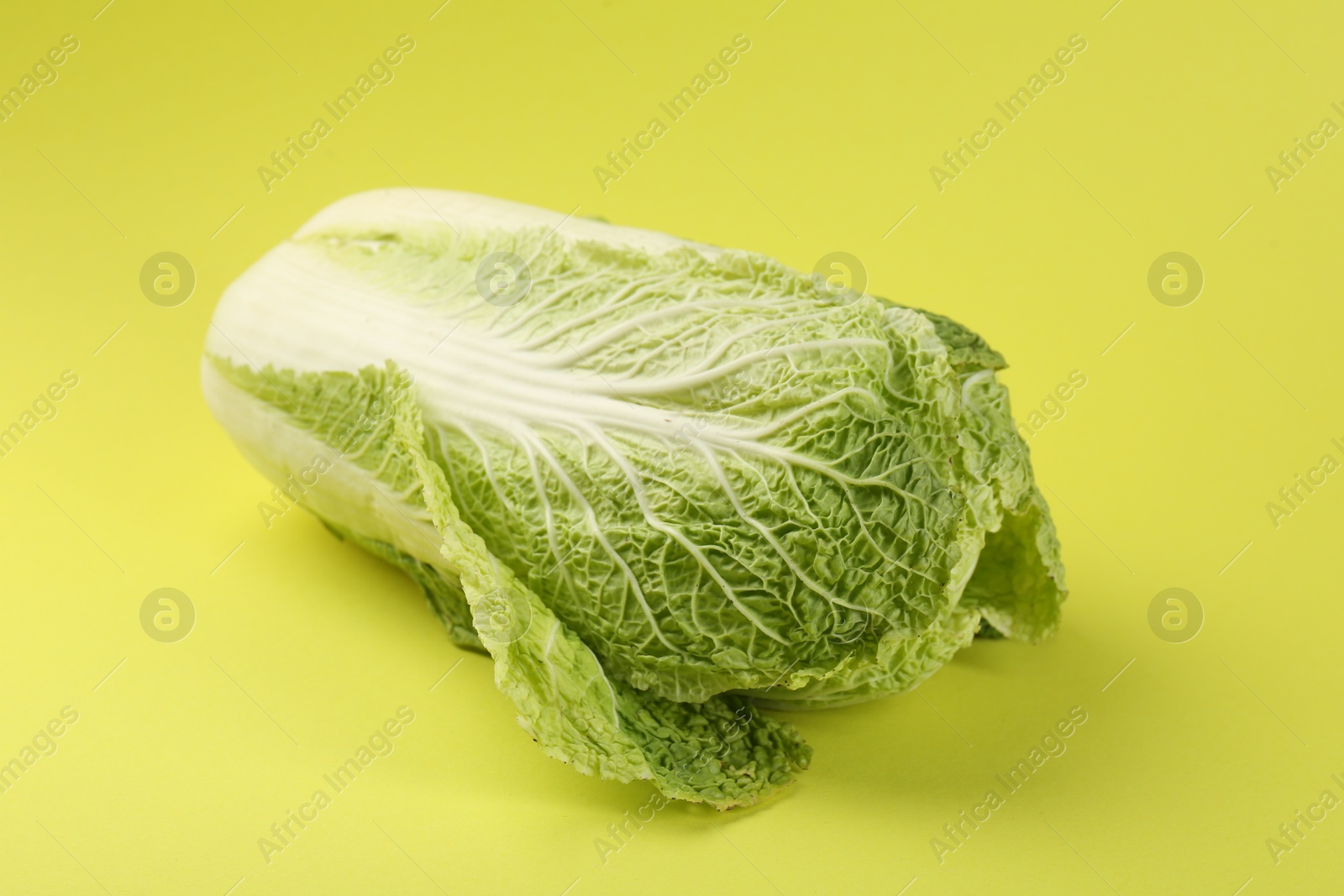 Photo of Fresh ripe Chinese cabbages on pale yellow background