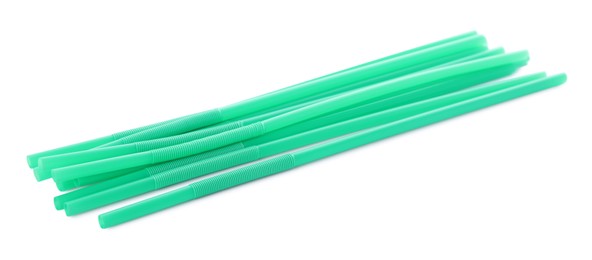 Green plastic cocktail straws on white background