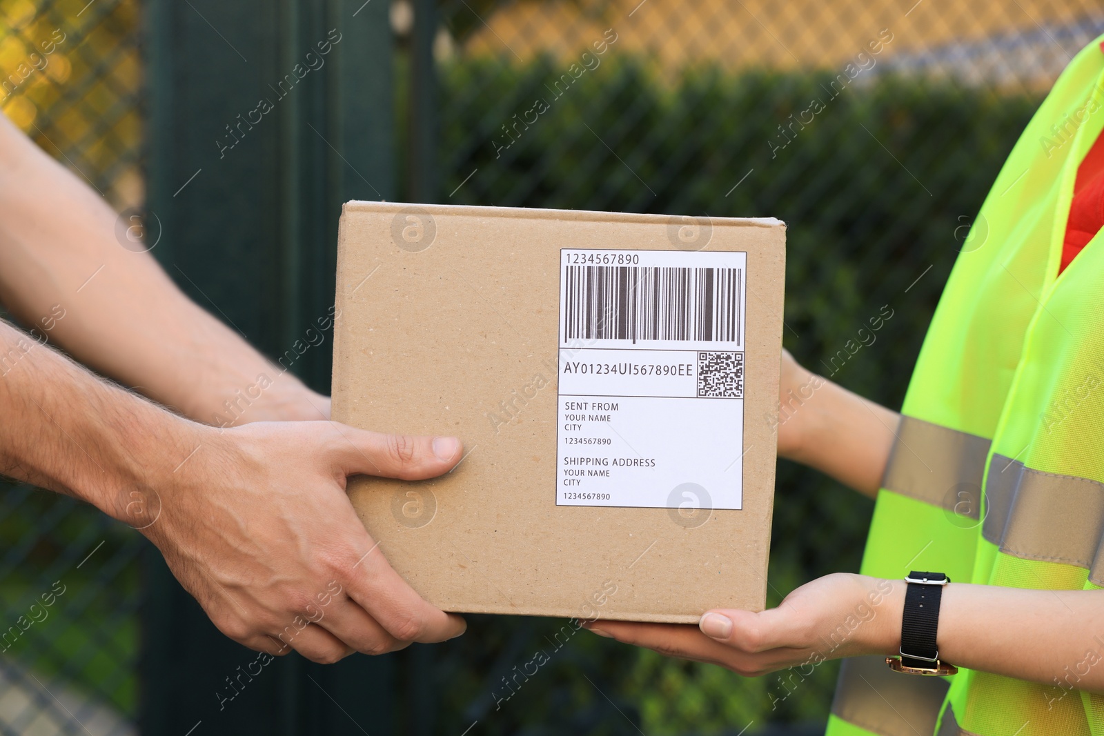 Photo of Man receiving parcel from courier outdoors, closeup