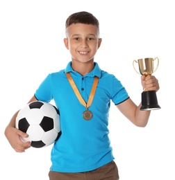 Photo of Happy boy with golden winning cup, medal and soccer ball on white background