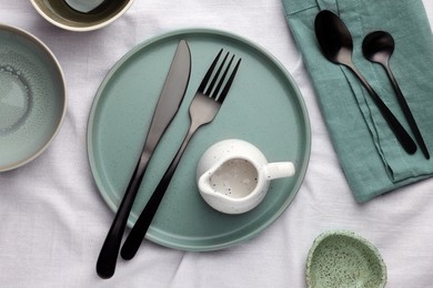 Stylish empty dishware and cutlery on table, flat lay