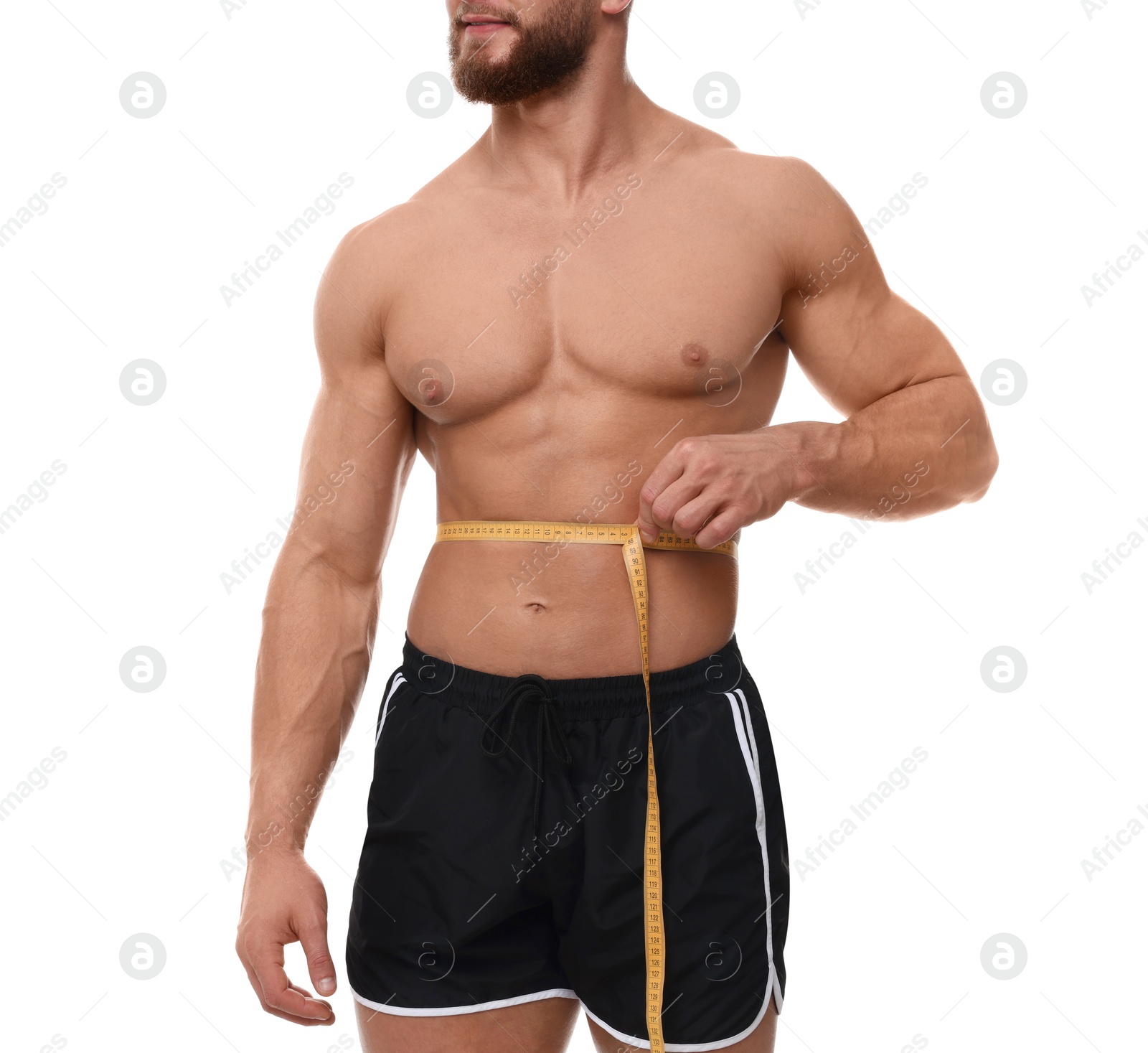 Photo of Athletic man measuring waist with tape on white background, closeup. Weight loss concept