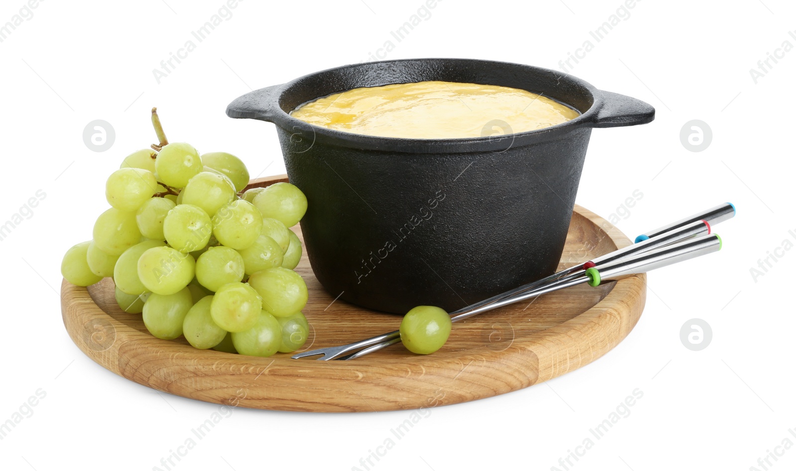 Photo of Fondue with tasty melted cheese, forks and grapes isolated on white