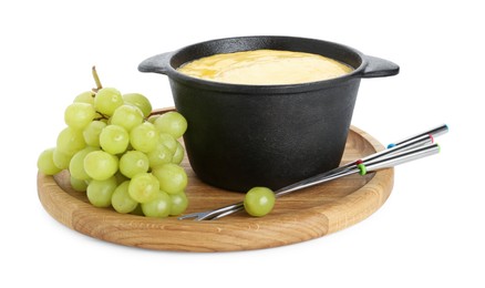 Fondue with tasty melted cheese, forks and grapes isolated on white