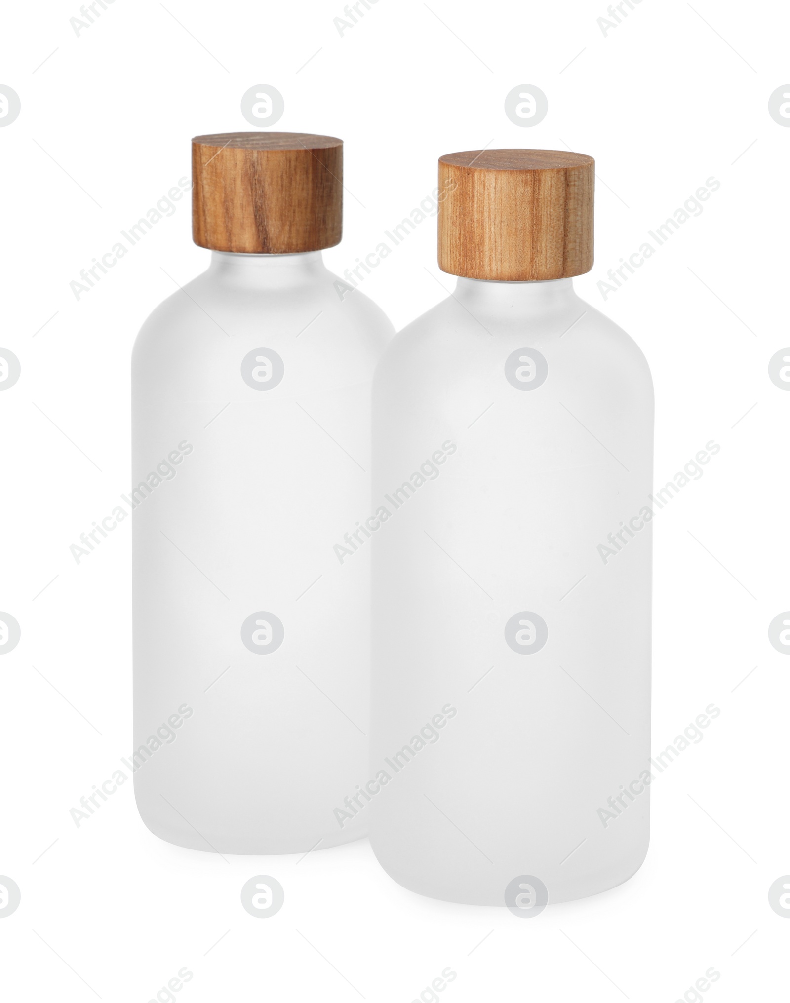 Photo of New empty glass bottles with wooden caps isolated on white