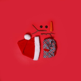 Photo of Set of elements for snowman on red background, flat lay