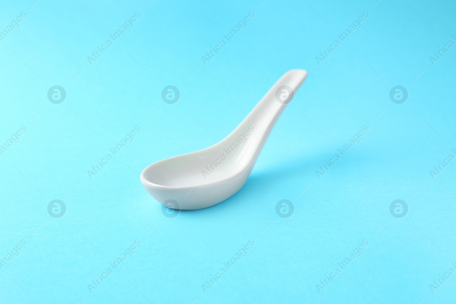 Photo of Clean Miso soup spoon on blue background