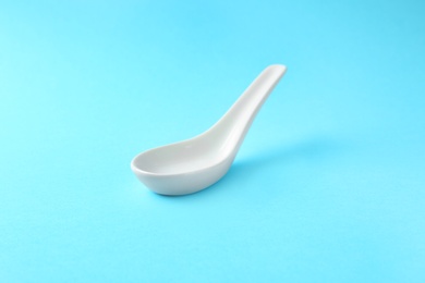 Photo of Clean Miso soup spoon on blue background