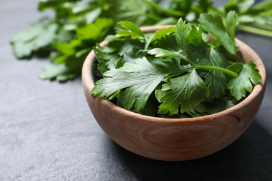 Fresh green parsley on grey table, closeup