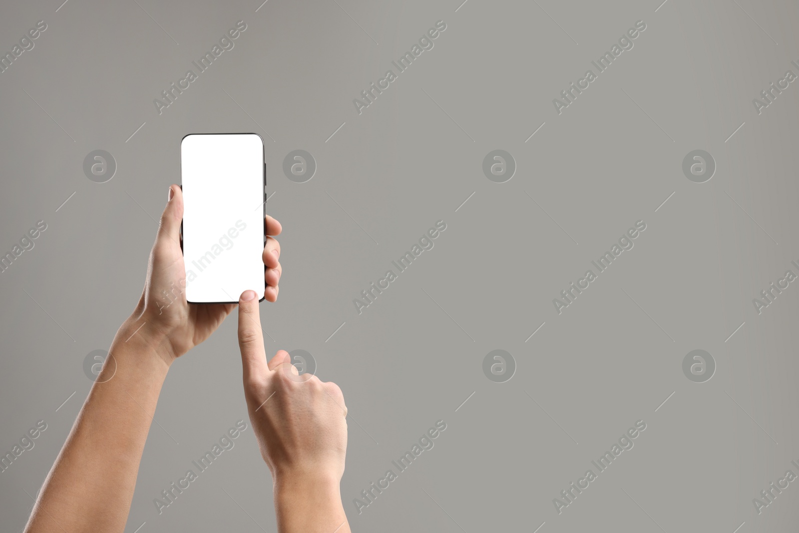 Photo of Man using smartphone with blank screen on light grey background, closeup. Mockup for design