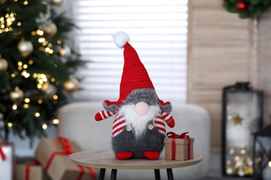 Photo of Cute Scandinavian gnome and Christmas gift box in room