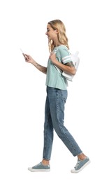 Young woman with smartphone walking on white background