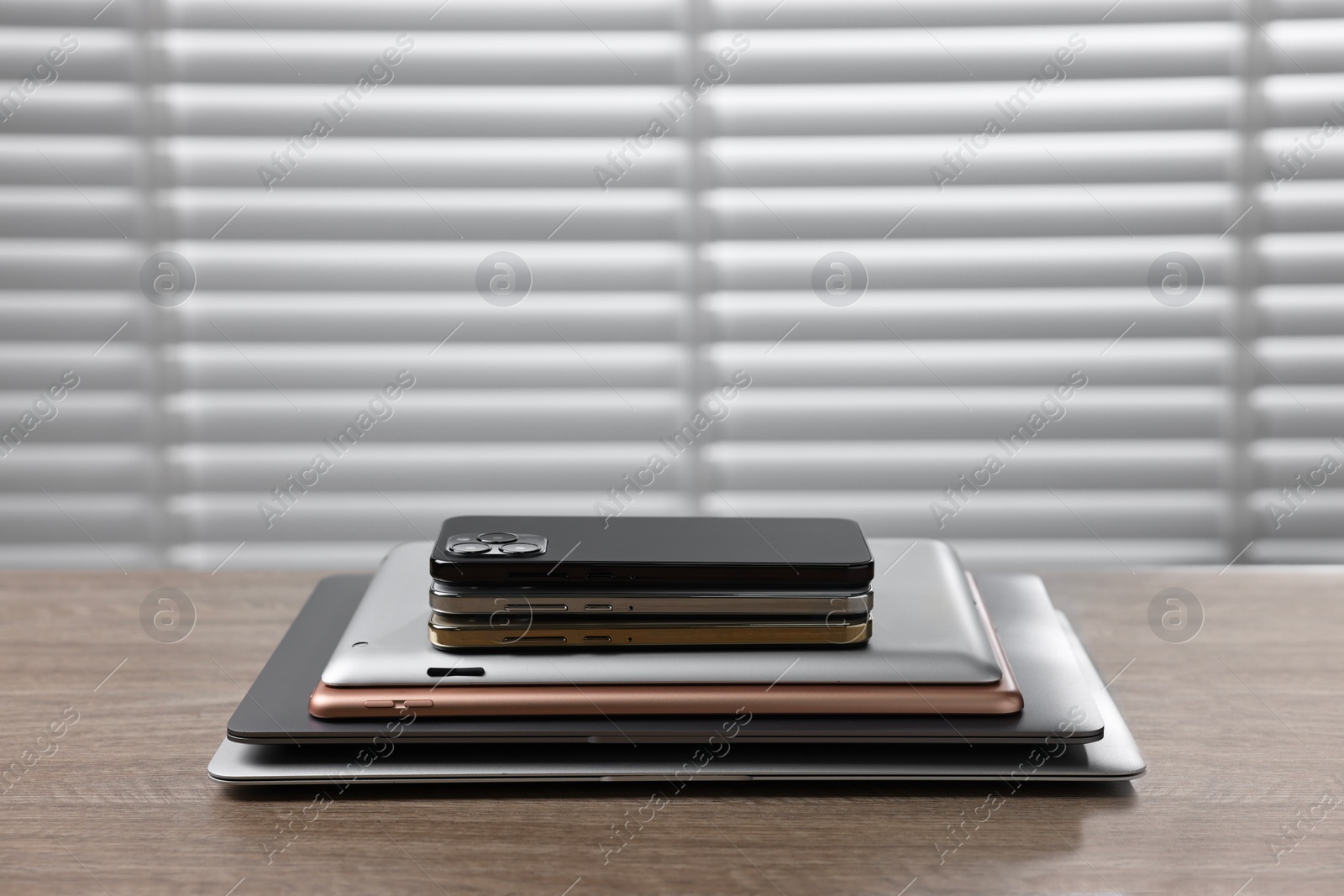 Photo of Many different modern gadgets on wooden table indoors. Space for text