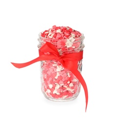 Photo of Bright heart shaped sprinkles in glass jar with red bow isolated on white