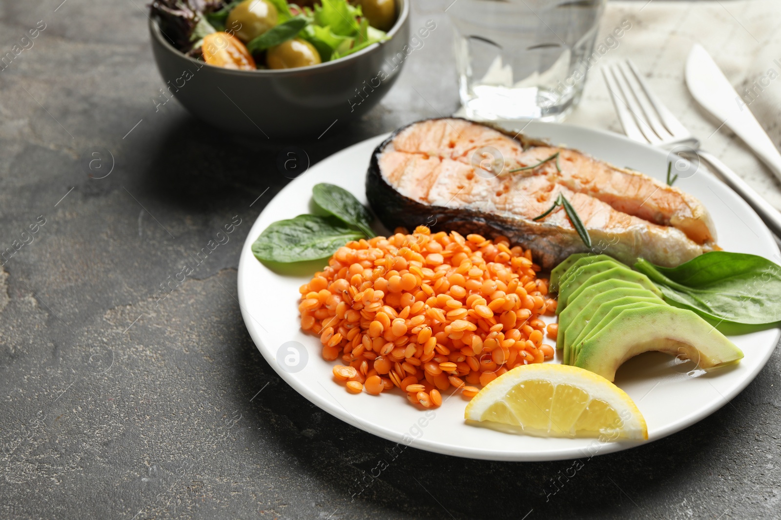 Photo of Healthy food high in vegetable fats on grey textured table, closeup. Space for text