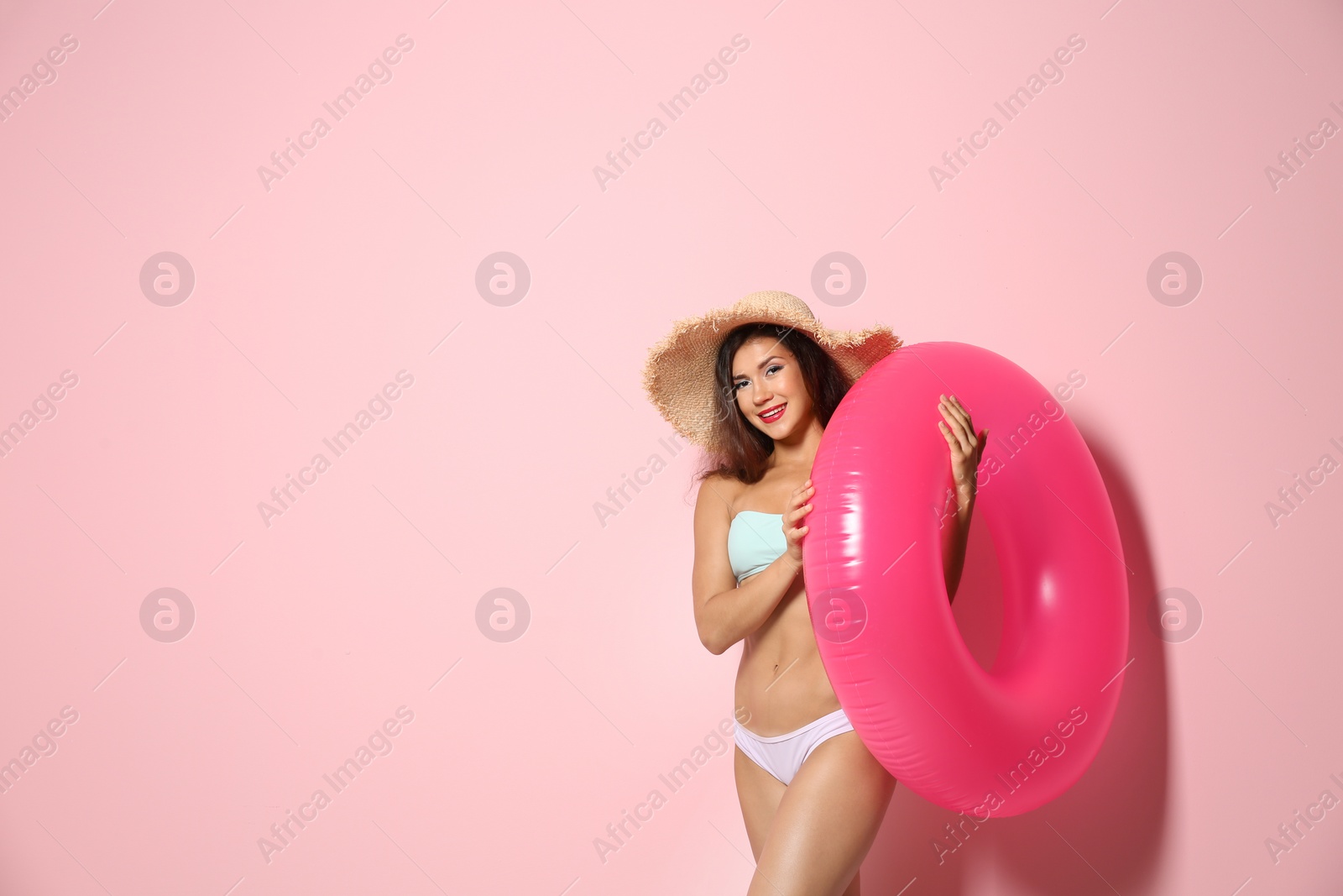 Photo of Beautiful young woman with inflatable ring on color background