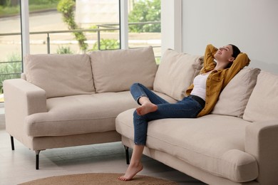 Photo of Teenage girl relaxing on sofa at home
