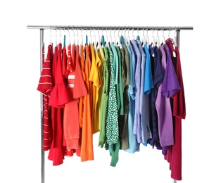 Wardrobe rack with different colorful clothes on white background