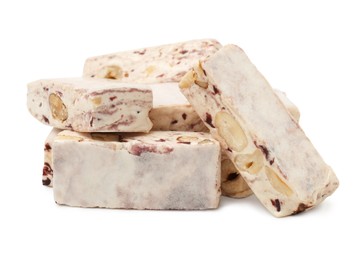 Many pieces of delicious nougat on white background