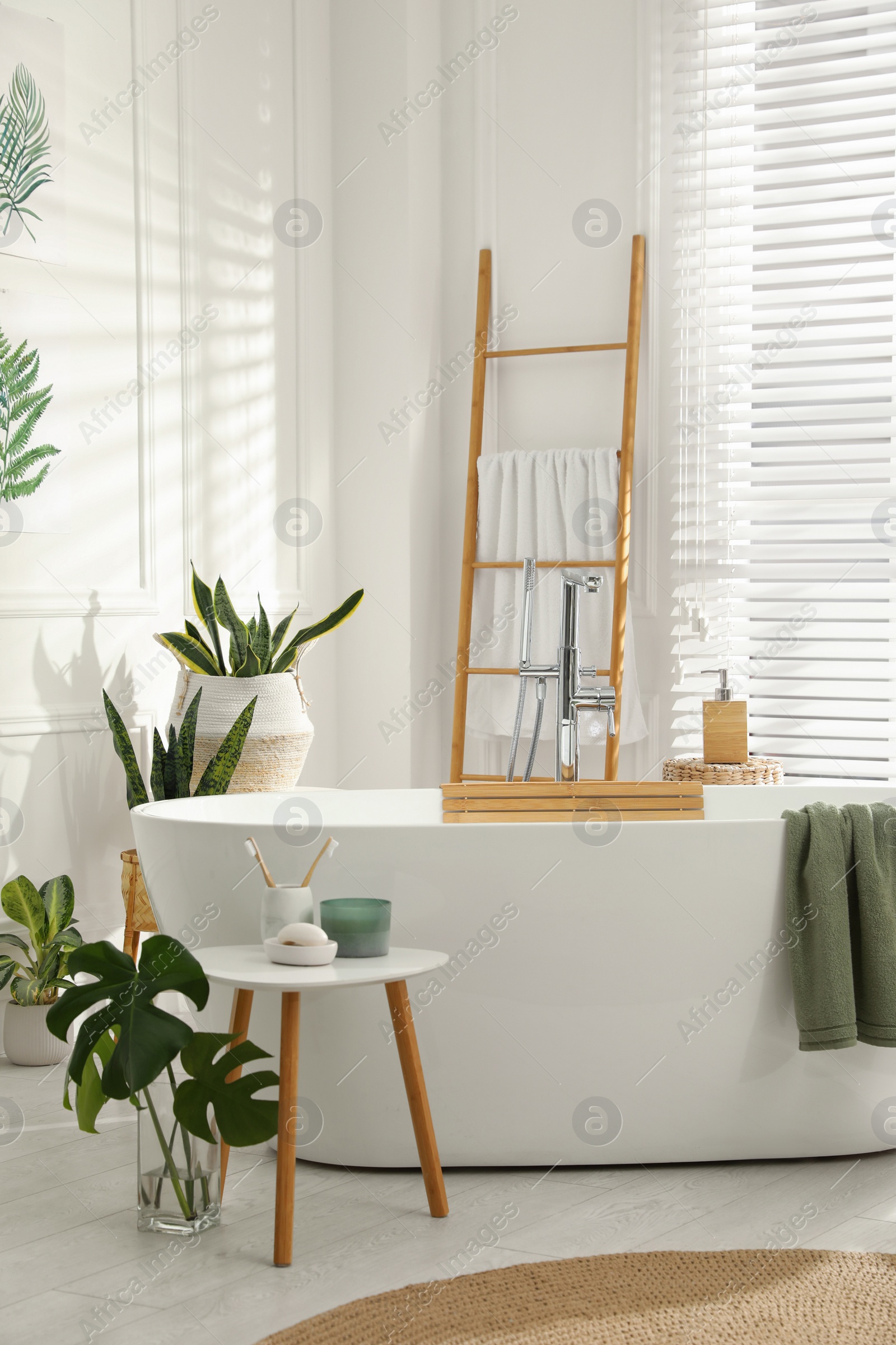 Photo of Stylish bathroom interior with green plants. Home design