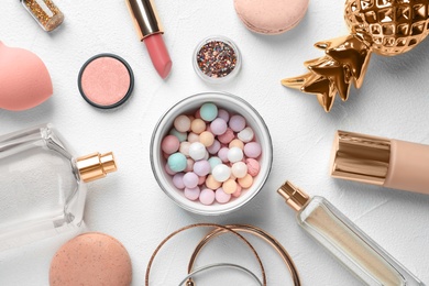 Flat lay composition with decorative cosmetics on light background