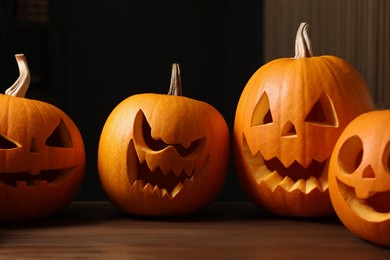 Photo of Carved pumpkins for Halloween on wooden table