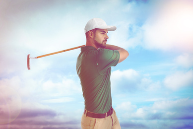 Image of Young man playing golf against blue sky. Space for design